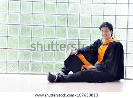 Fashion of graduate in thailand ,graduation boy holding his master\'s degree.And business action.