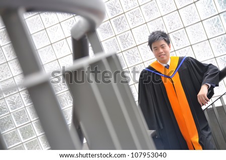 Fashion of graduate in thailand ,graduation boy holding his master's degree.And business action.