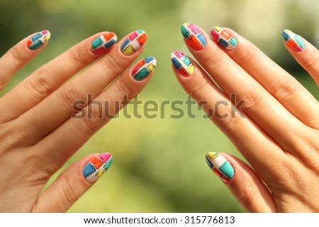 Nail design .  Manicure nail paint . beautiful female hand with colorful  nail art design manicure