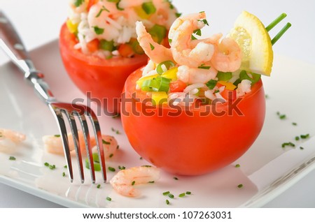 Stuffed tomatoes with shrimps, rice, bell peppers, spring onions, lemon, chives and parsley. A very delicious appetizer
