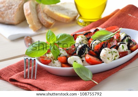 Salad with tomatoes, mozzarella and basil, served with Italian ciabatta bread