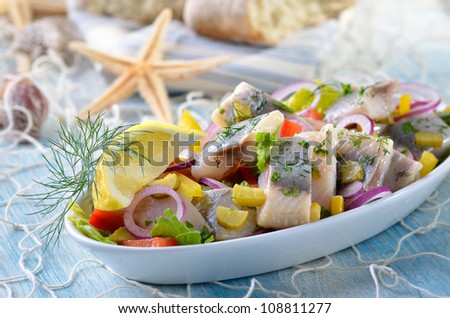 Delicious salad of salted fillets of white herring