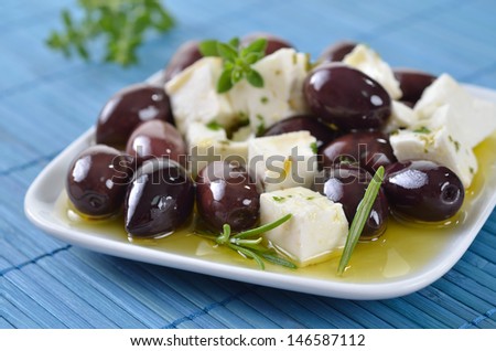Greek Kalamata olives and feta cheese with olive oil, a mediterranean snack