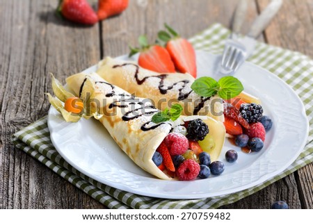 Two homemade pancakes stuffed with mixed berries