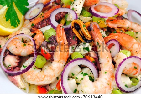 Seafood Salad Salad with prawns, mussels, squids, onions and spring onions decorated by lemon and parsley.