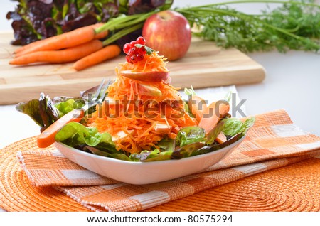 Salad of carrots and apples on curled lettuce