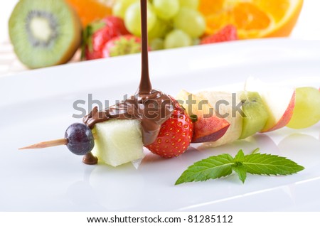 Ripe fruit in season with milk chocolate coating