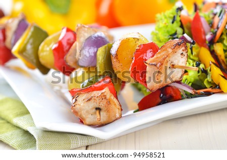 Shish kebab with pork, potatoes, vegetables and salad