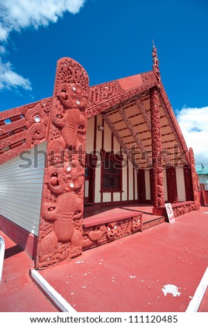 This image shows a maori marae (meeting house and meeting ground)