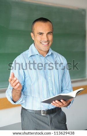 This image shows a Hispanic Male Teacher in his classroom