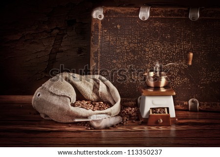 Fresh coffee beans on wood and linen bag, ready to brew delicious coffee