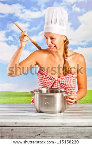 young woman in a chef's hat - it bread, cooking, drinking milk, on background of the sky - picnic