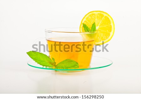 tea in cup with leaf mint and lemon