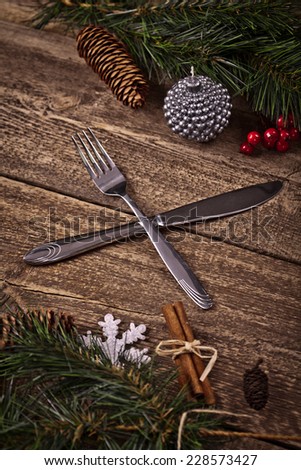 Vintage silverware on rustic wooden background with christmas decoration