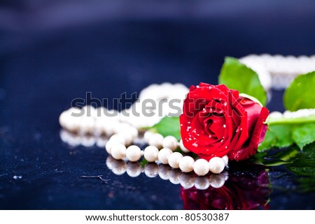 flowers up close on a black background with pearls, drops of water, roses, gerbera