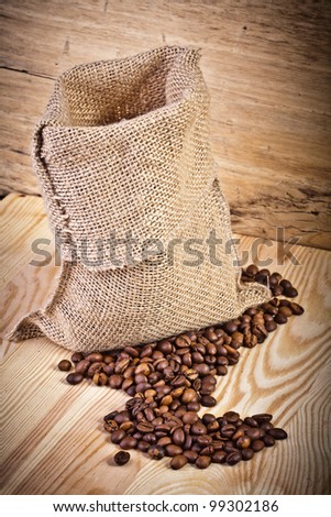 Aromatic coffee beans in a bag linen and wood