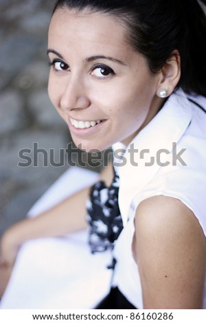 Young beautiful student with white copybook smiling