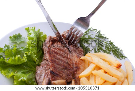 Stake with potato free on the plate isolated on white