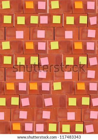 Color sticky note on  brick wall