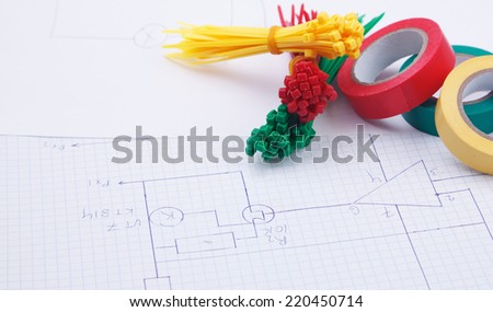 Plastic ties and color insulation tape  on a background of the electric scheme