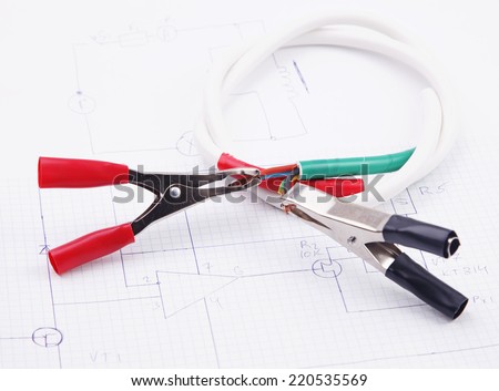 Electric clamps and electric cable on a background of the electric scheme