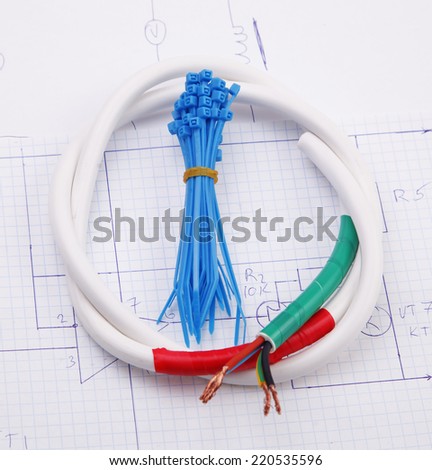 Plastic ties and electric cable on a background of the electric scheme