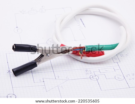 Electric clamps and electric cable on a background of the electric scheme