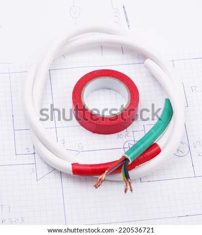 Adhesive plastic tape and electric cable on the background on the electric scheme