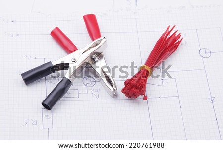 Electric clamps and plastic ties on electric scheme background