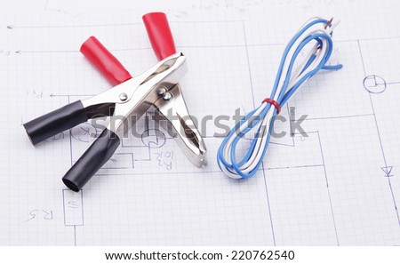 Electric clamps and electric cable on the background electric scheme