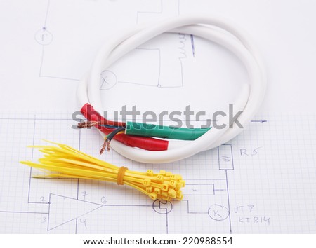 Plastic ties and electric cable on the background of the electric scheme