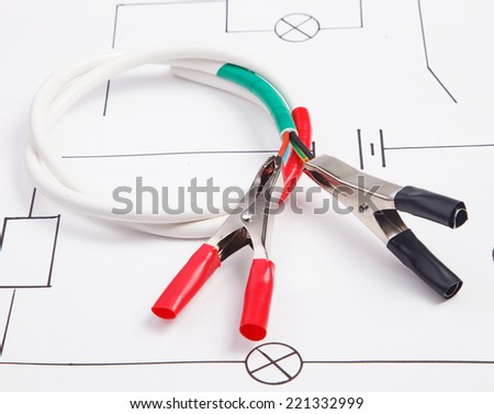 Electric clamps and adhesive plastic tape on a background of the electric scheme