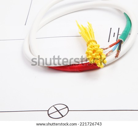 Plastic ties and electric cable on a background of the electric scheme