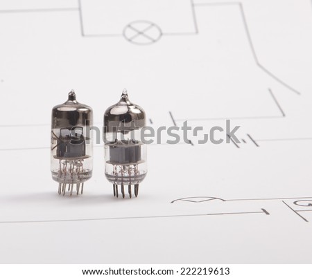 Vintage electron tube on a background of the electric scheme