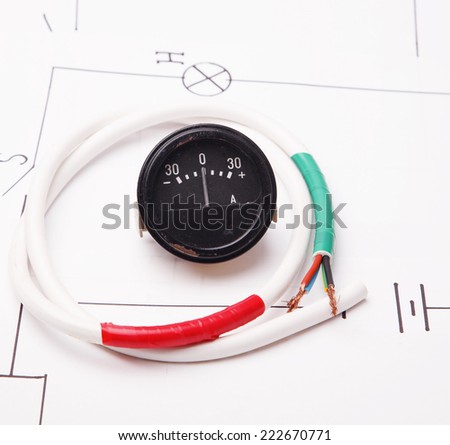 Ammeter and electric wire on a background of the electric scheme