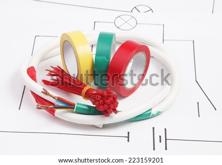 Adhesive plastic tape and electric cable on a background of the electric scheme
