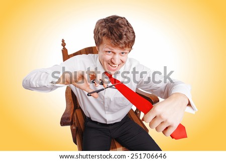 Businessman with scissors cuts the tie on white