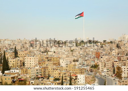 Amman city view with big Jordan flag and flagpole