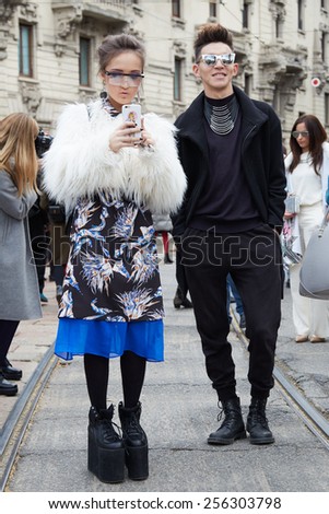 MILAN - FEBRUARY 25: Woman and man poses for photographers before Gucci show Milan Fashion Week Day 1, Fall/Winter 2015/2016 street style day 1, on February 25, 2015 in Milan.