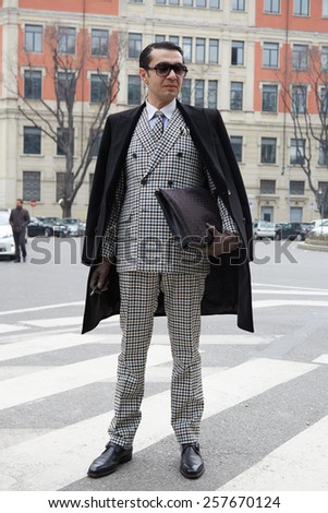 MILAN - FEBRUARY 27: Man poses for photographers before Emporio Armani show Milan Fashion Week Day 3, Fall/Winter 2015/2016 street style on February 27, 2015 in Milan.