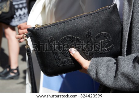 PARIS - SEPTEMBER 29: Woman holding black love bag before Nehera show, Paris Fashion Week Day 1, Spring / Summer 2016 street style on September 29, 2015 in Paris.