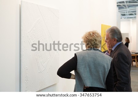 TURIN, ITALY - NOVEMBER 6: Artissima, contemporary art fair opening with people, galleries and art collectors on November 6, 2015 in Turin, Italy. Elderly couple looking at white painting.