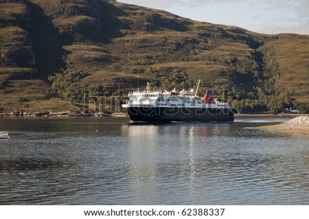 Car ferry rounding the point at the entrance to Ullapool harbour in the Highlands of Scotland