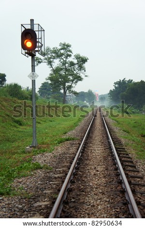 Railway track with Traffic light towards city