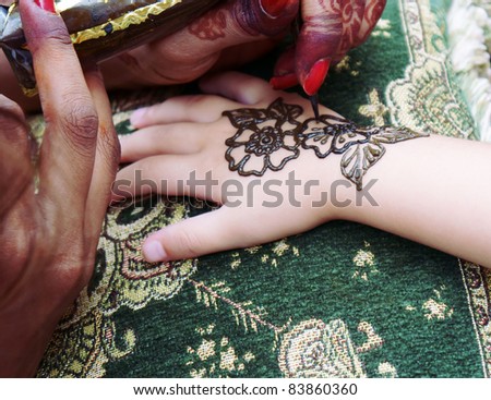 stock photo Child hand on the process of being decorated with henna tattoo