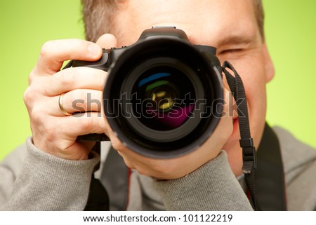 Male photographer taking photos with DSLR digital camera