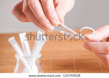 Hand reaching for acupuncture needle