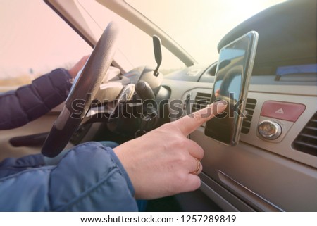 Woman using smart phone as navigation while driving the car. Risky driving behaviors concept