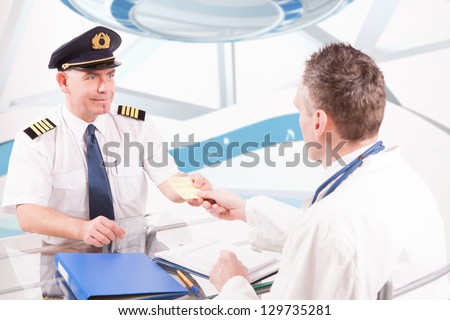 Airplane pilot during medical exam with doctor giving him a medical certificate