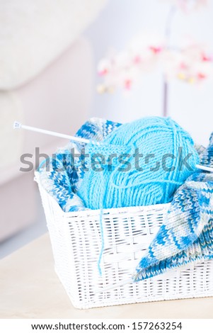 Basket with ball of knitting yarn and knitting needle